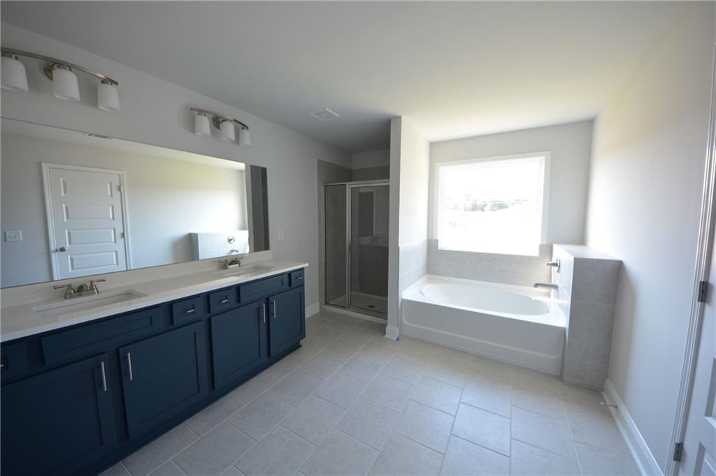 3871 Brookburn Park Gainesville, GA 30506 - Photo 21 of 28 a bathroom with a tub sink shower and a mirror