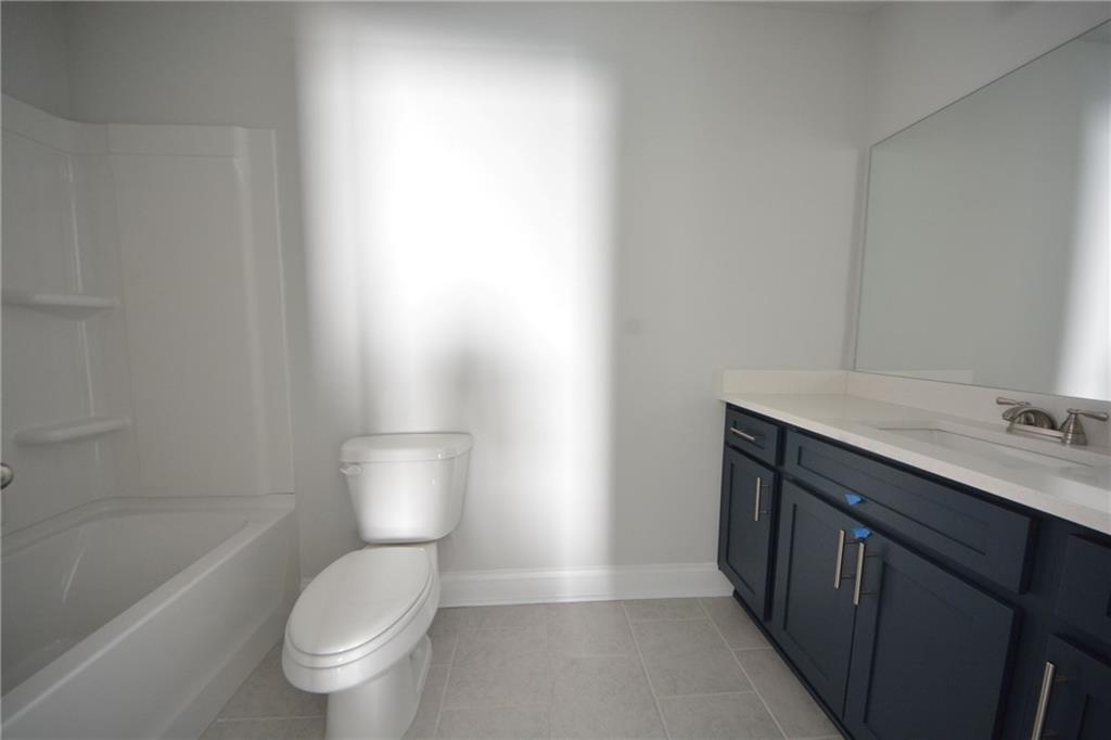 3871 Brookburn Park Gainesville, GA 30506 - Photo 26 of 28 a bathroom with a toilet a sink and mirror