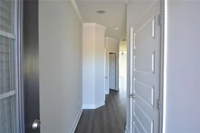 a view of entryway and hall with wooden floor