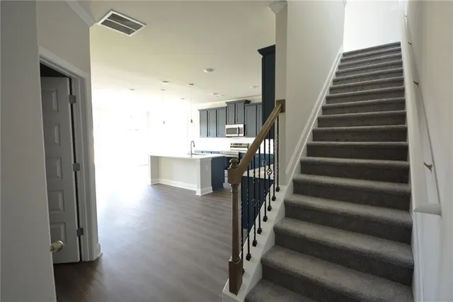 a kitchen with kitchen island granite countertop a sink and cabinets