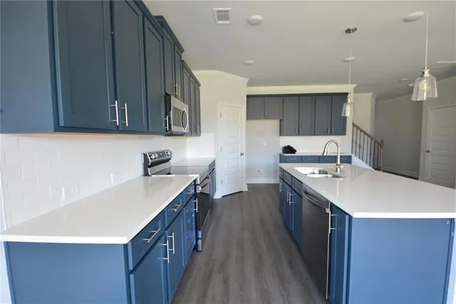 a kitchen with wooden cabinets and stainless steel appliances