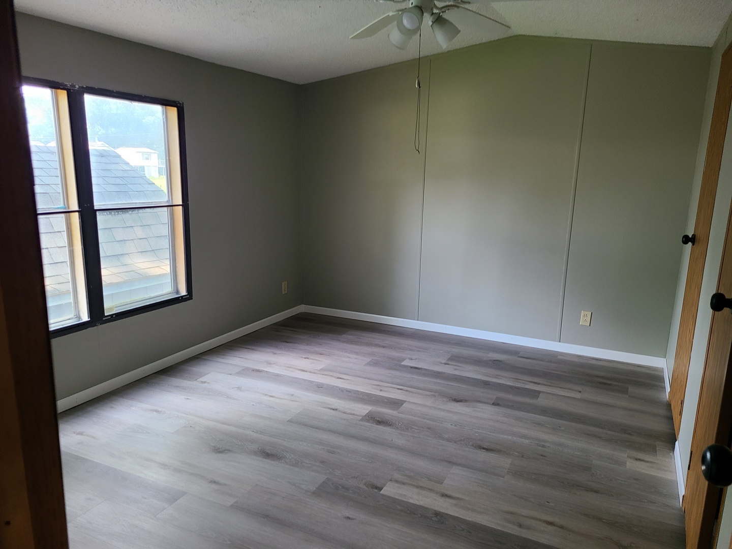 1931 Champlain Street, Unit 17 Ottawa, IL 61350 - Photo 7 of 13 an empty room with wooden floor and windows