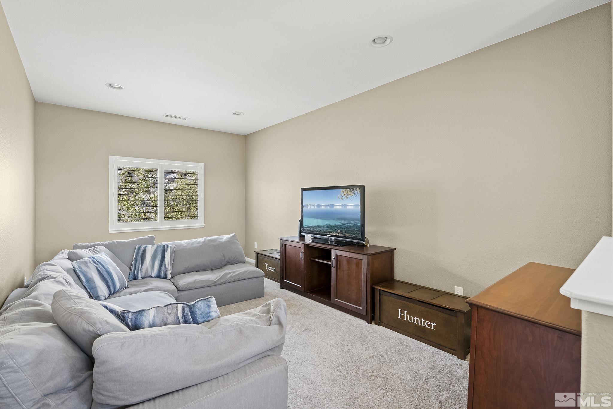 1653 Crescent Pointe Court Reno, NV 89523 - Photo 15 of 39 a living room with furniture and a flat screen tv