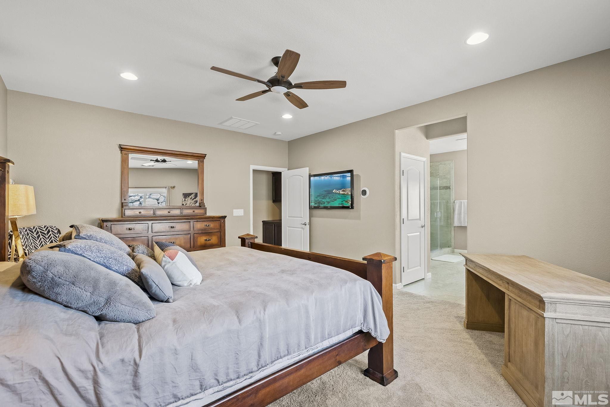 1653 Crescent Pointe Court Reno, NV 89523 - Photo 17 of 39 a bedroom with a large bed and a chandelier