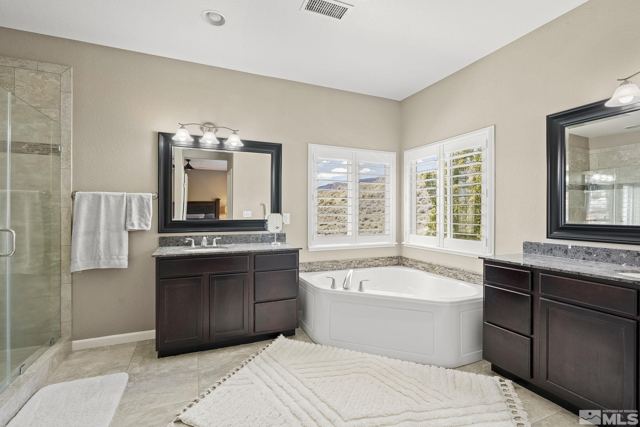 1653 Crescent Pointe Court Reno, NV 89523 - Photo 18 of 39 a bathroom with a tub sink and mirror