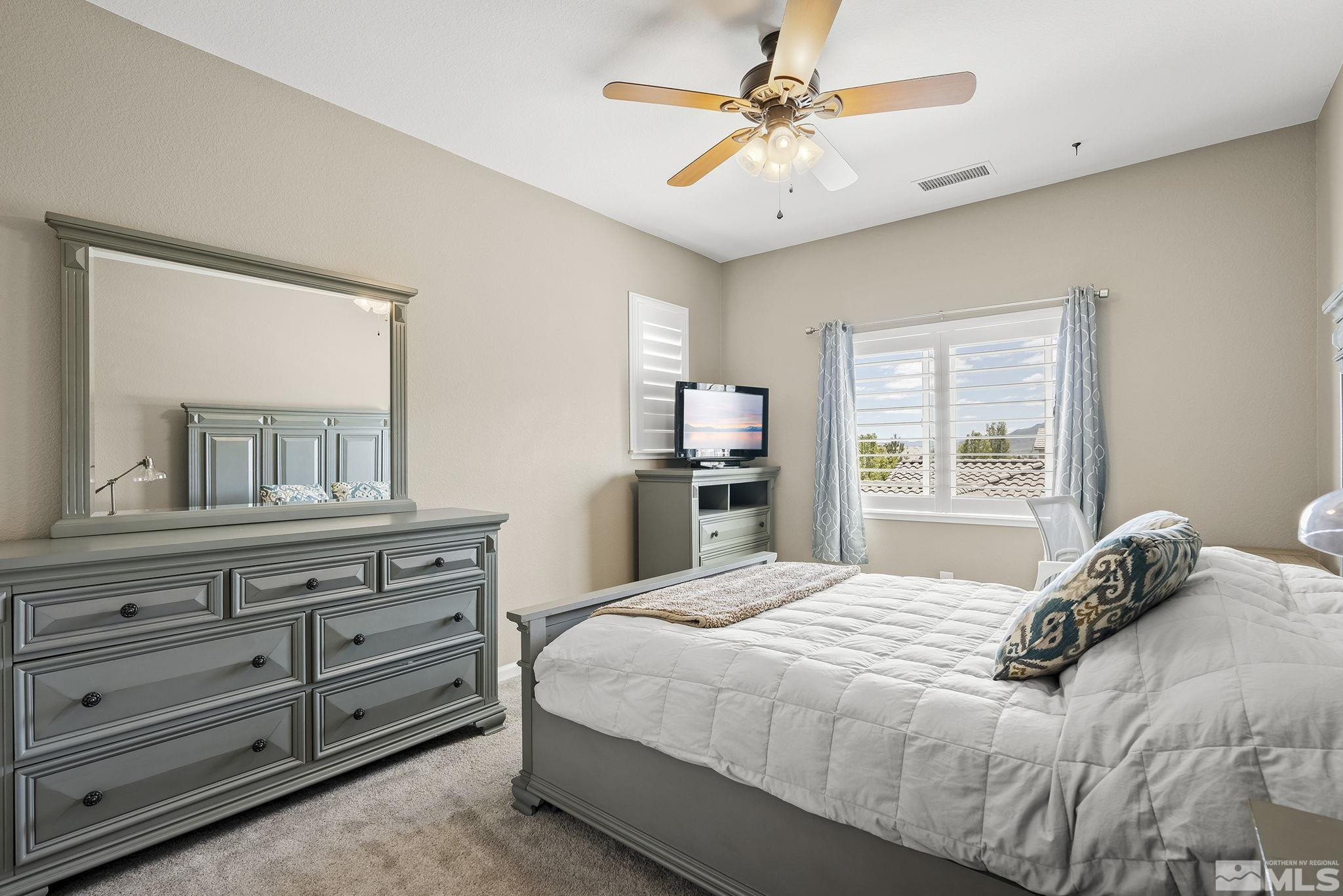 1653 Crescent Pointe Court Reno, NV 89523 - Photo 19 of 39 a bedroom with a large bed and a dresser