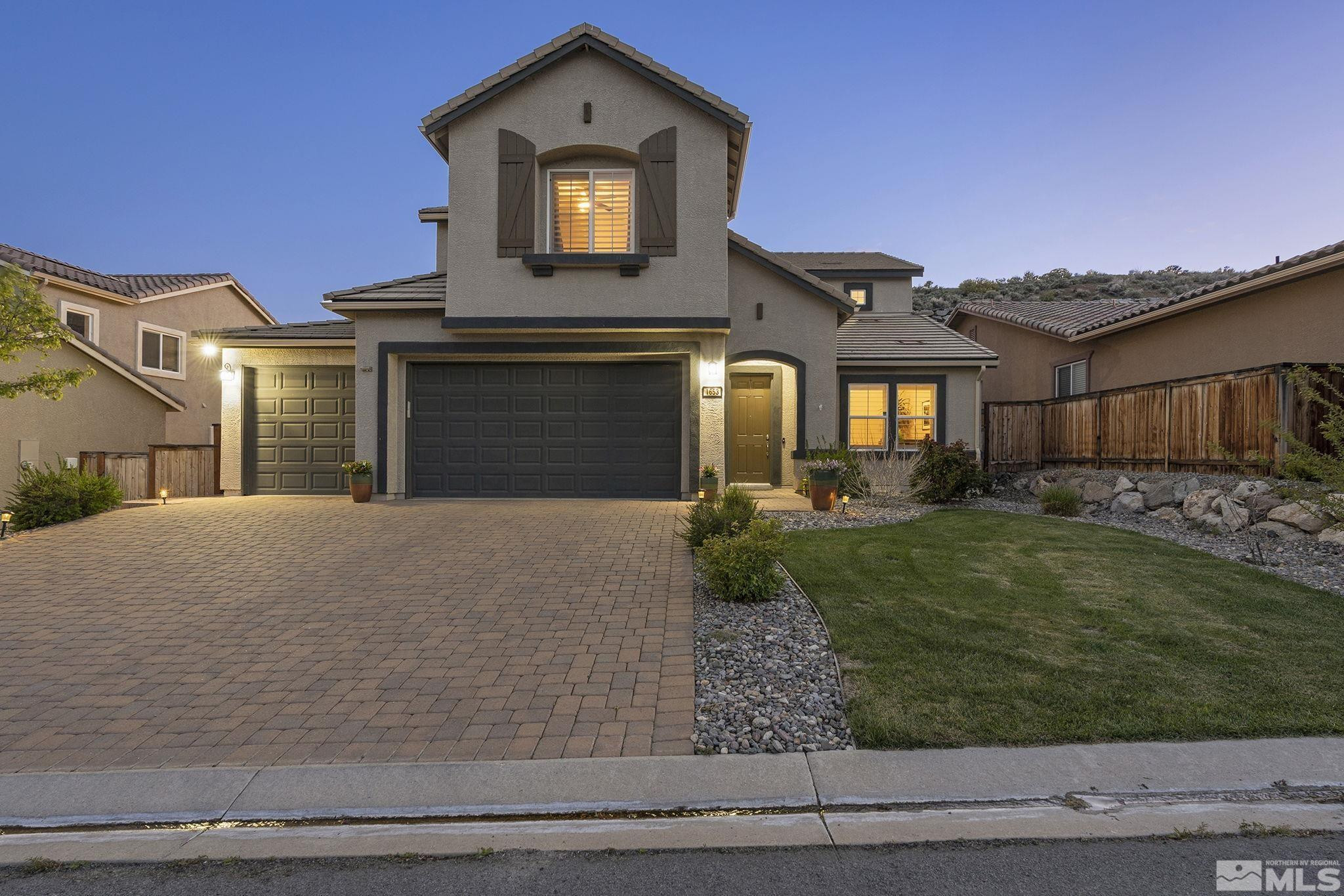 1653 Crescent Pointe Court Reno, NV 89523 - Photo 2 of 39 a front view of a house with garden