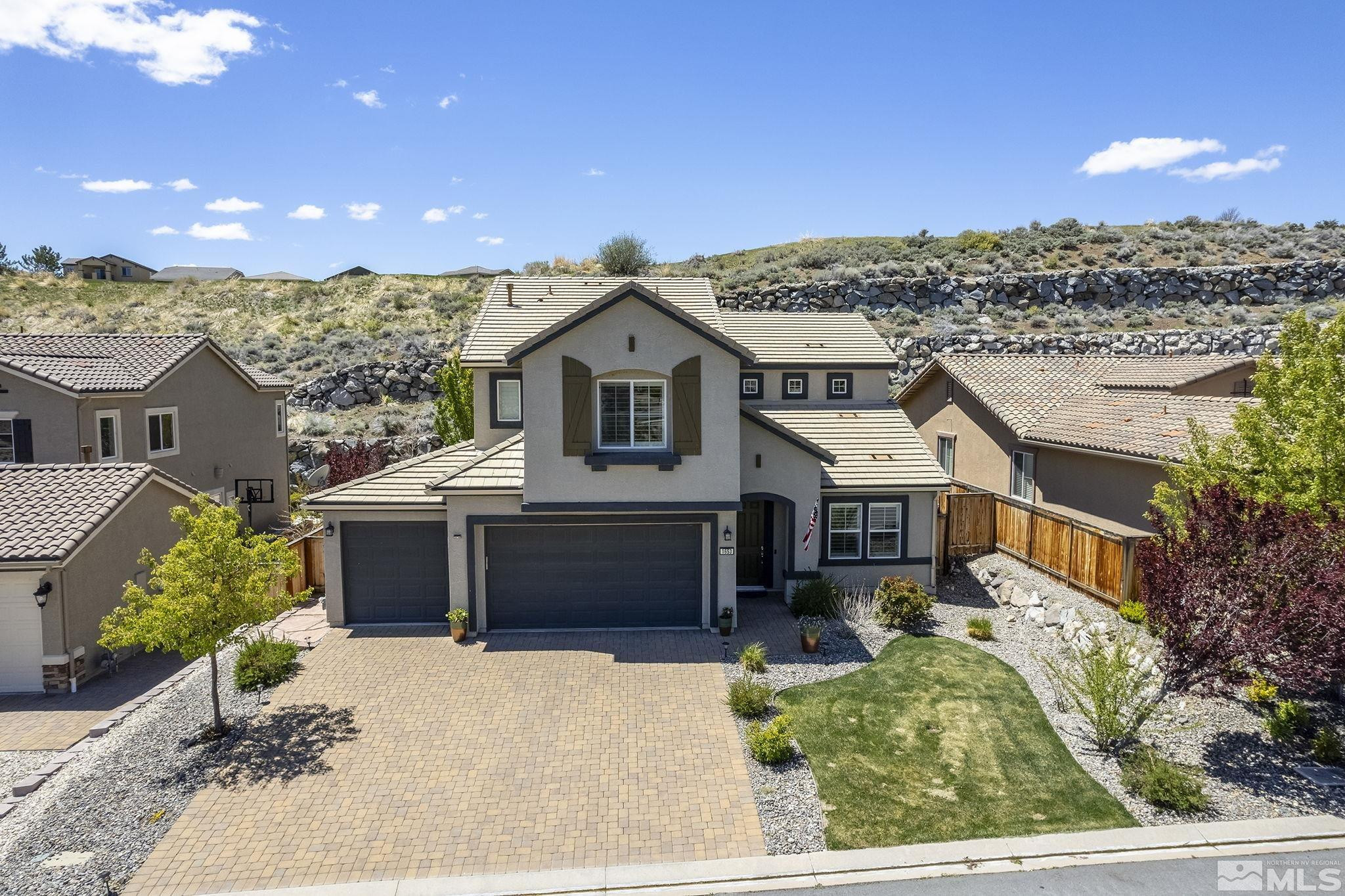 1653 Crescent Pointe Court Reno, NV 89523 - Photo 32 of 39 a front view of a house with a garden