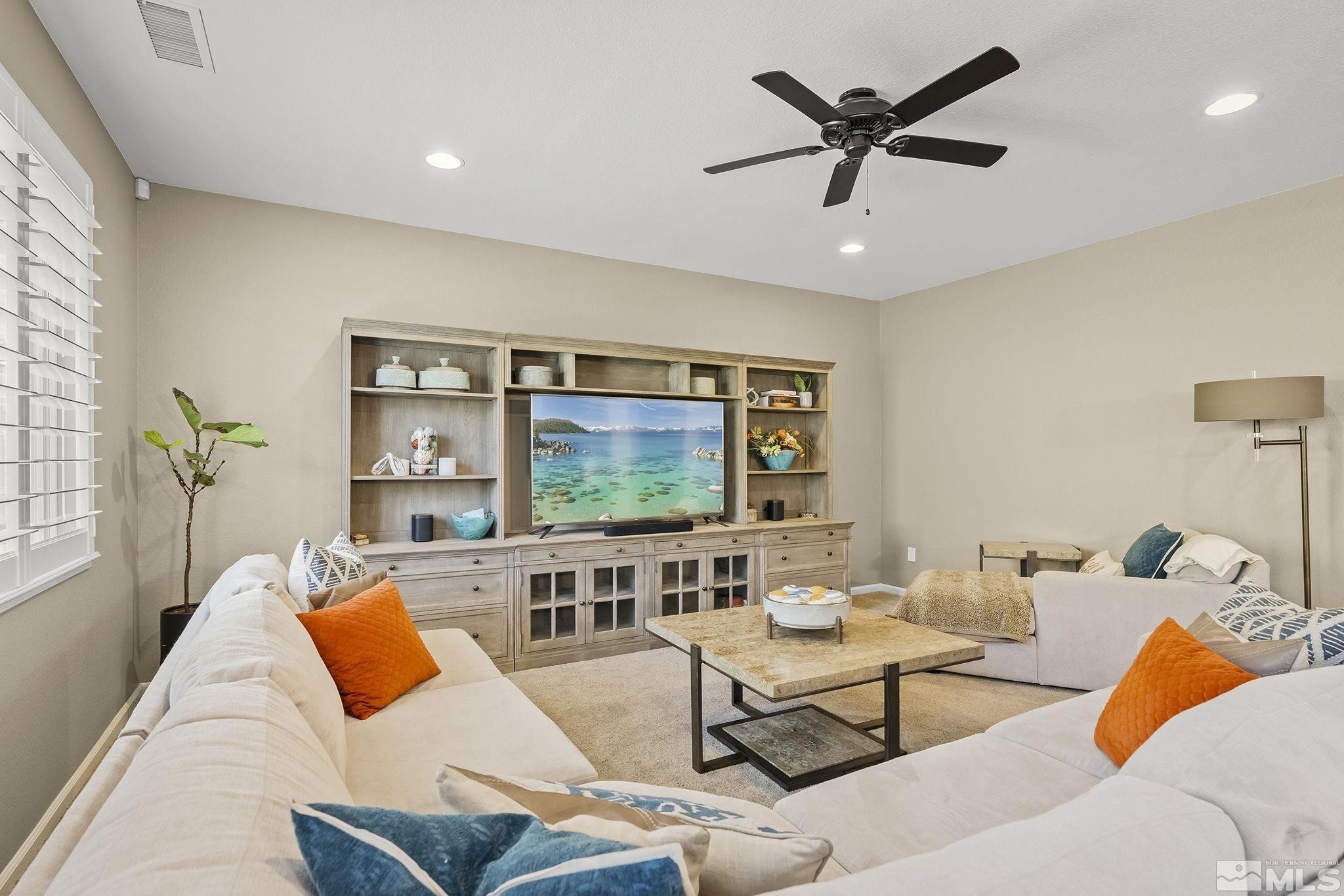 1653 Crescent Pointe Court Reno, NV 89523 - Photo 6 of 39 a living room with furniture and a flat screen tv