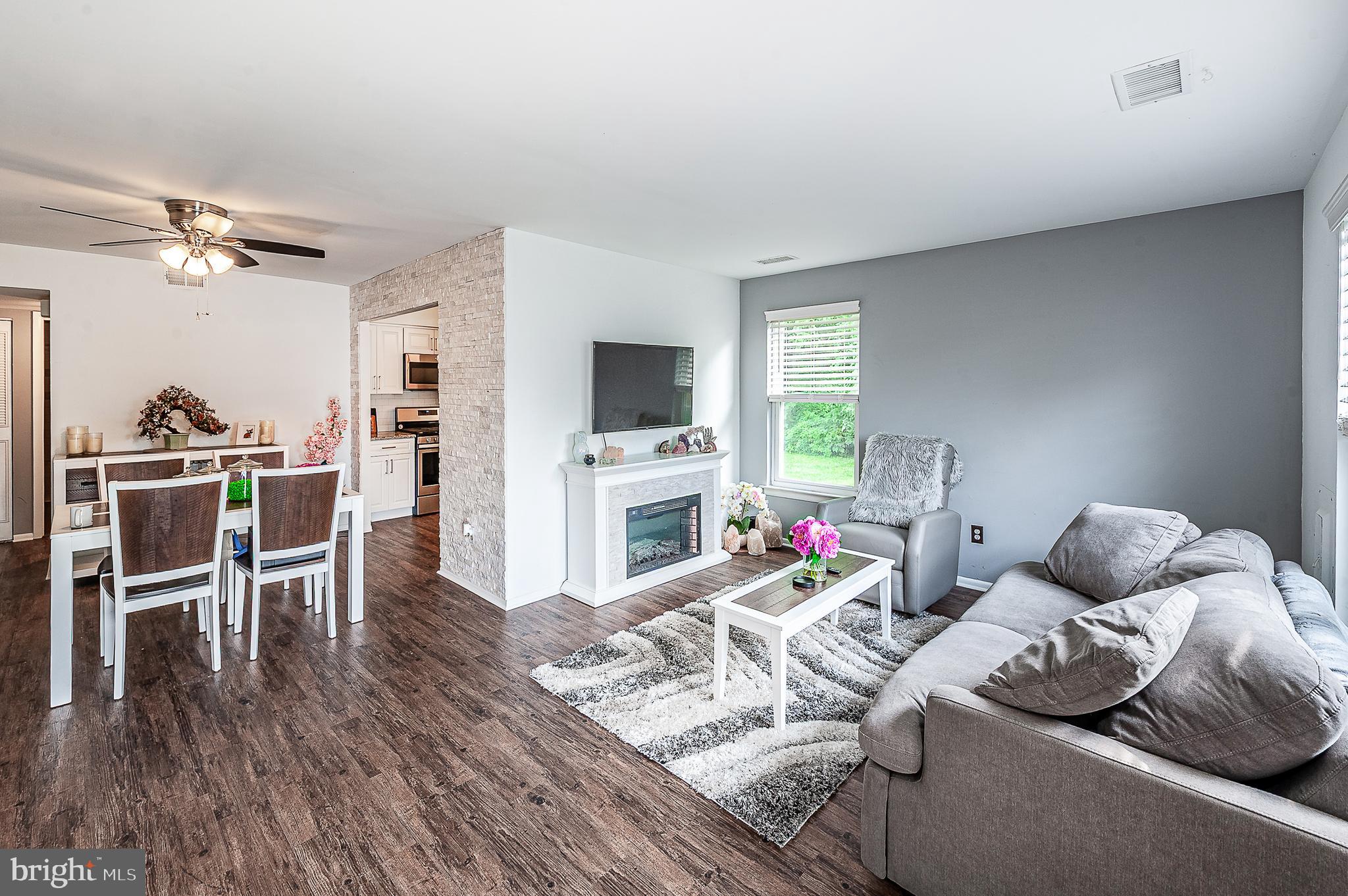 102 Brookdale Place Clementon, NJ 08021 - Photo 4 of 25 a living room with furniture a fireplace and a flat screen tv