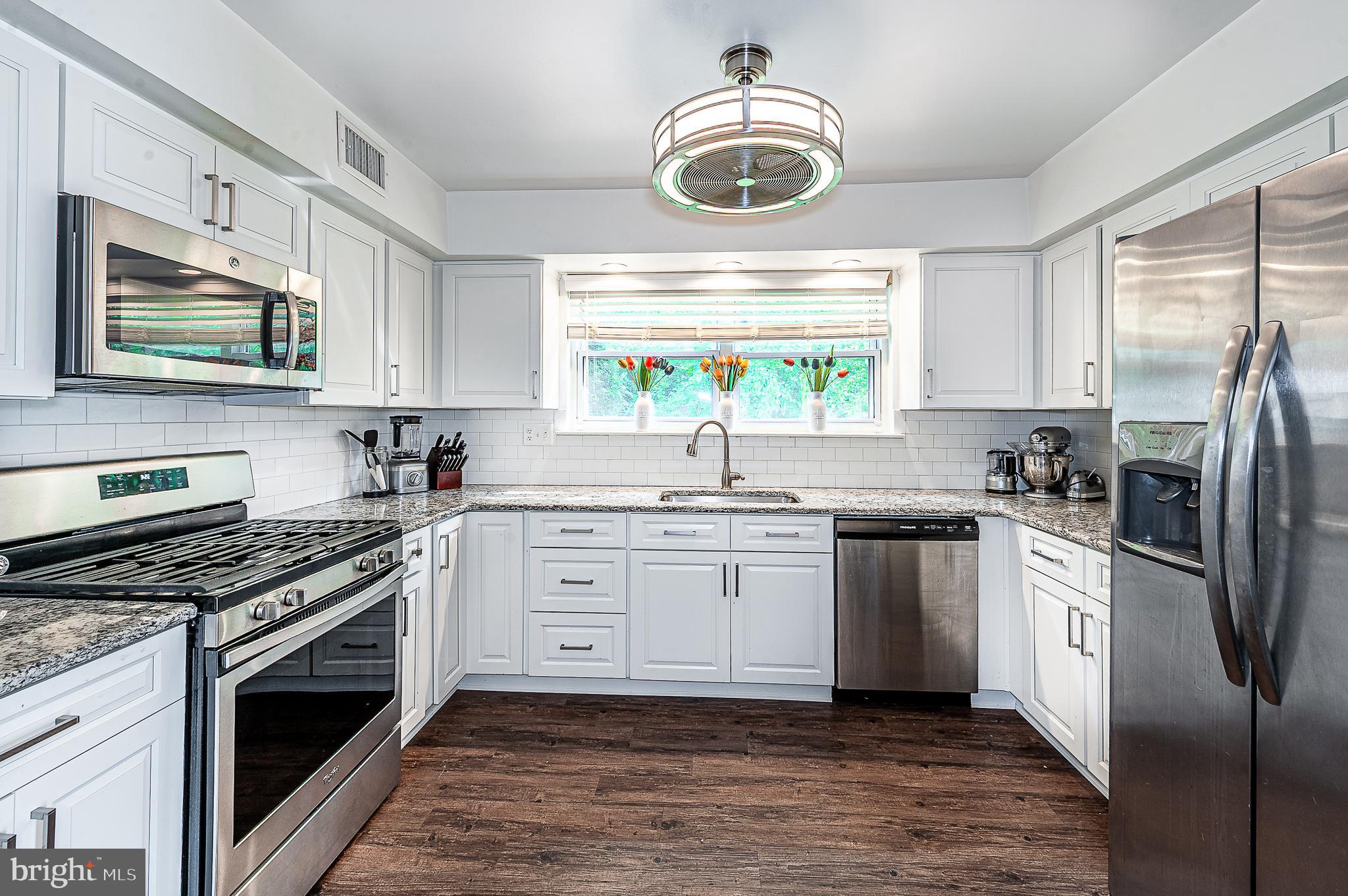102 Brookdale Place Clementon, NJ 08021 - Photo 8 of 25 a kitchen with stainless steel appliances a stove a sink and a window