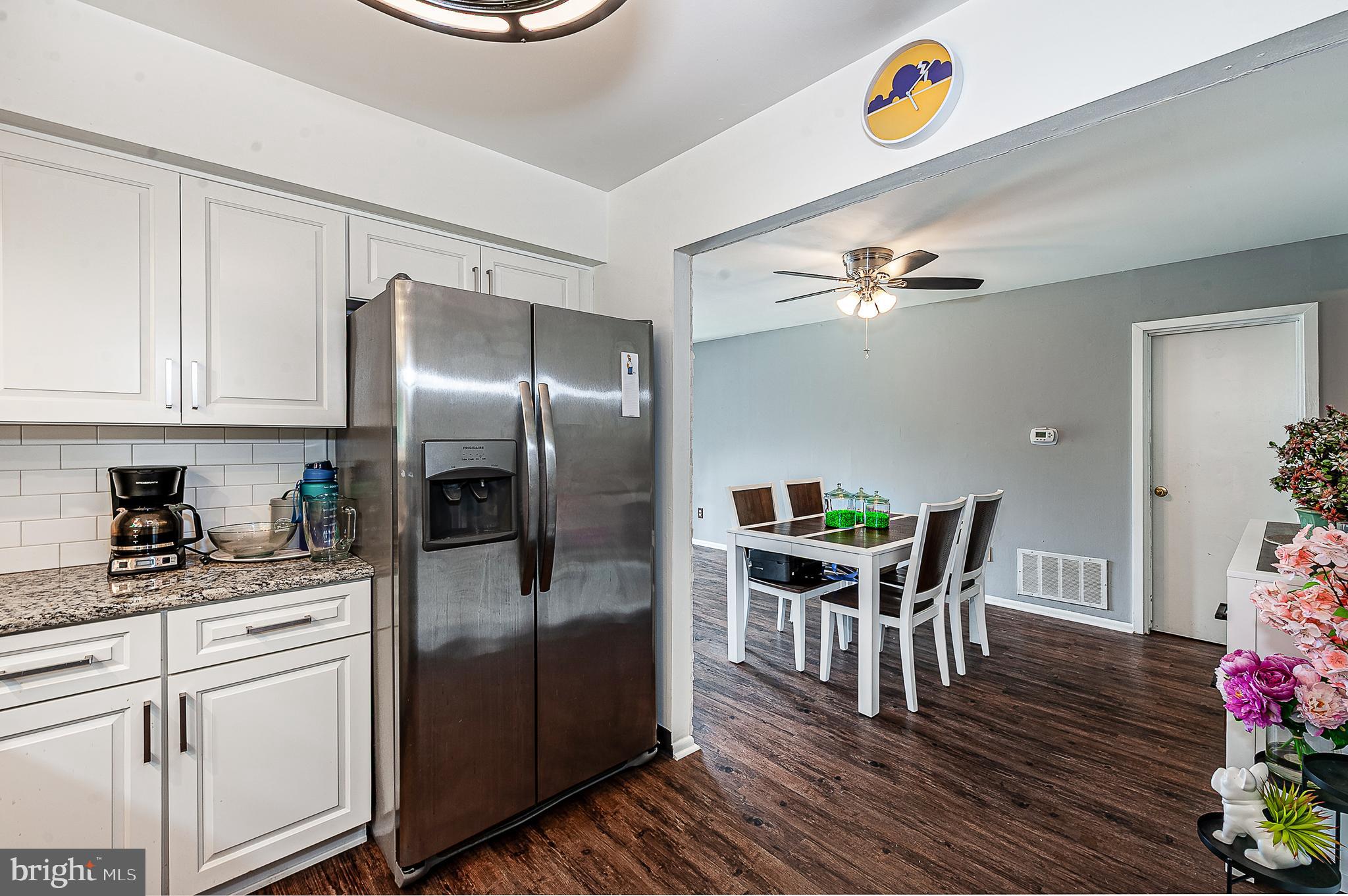 102 Brookdale Place Clementon, NJ 08021 - Photo 10 of 25 a kitchen with stainless steel appliances granite countertop a refrigerator a stove and a dining table with wooden floor