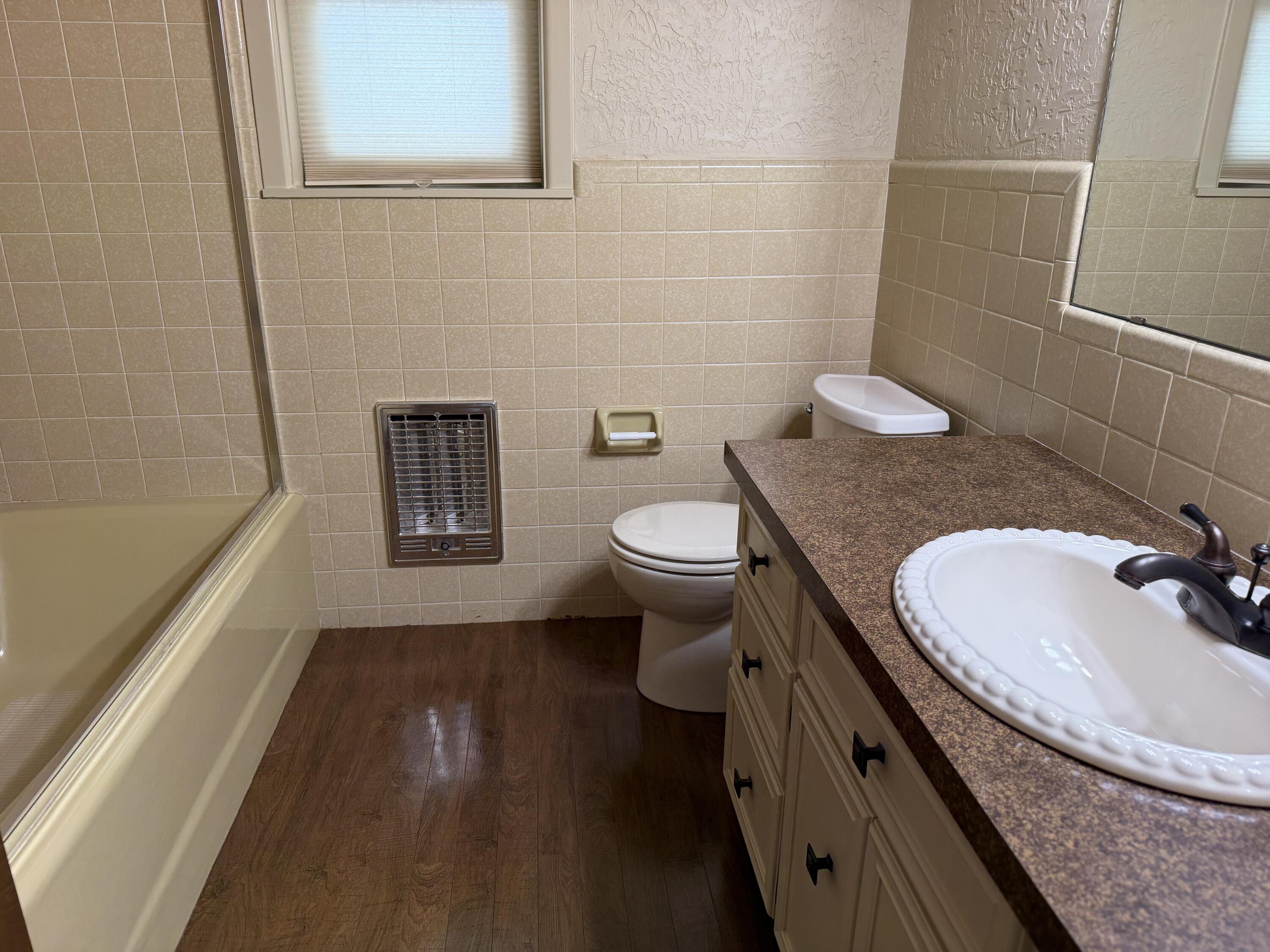 1603 South 8th Street Lamesa, TX 79331 - Photo 24 of 39 a bathroom with a granite countertop sink a toilet and shower