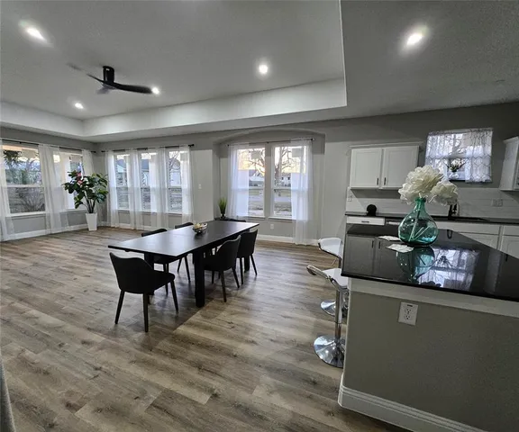 a dining room with furniture and wooden floor