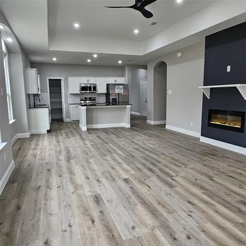 a view of kitchen with cabinets and wooden floor