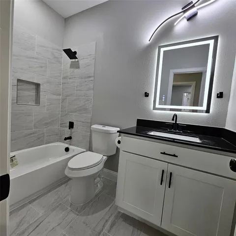 a bathroom with a toilet a sink and bathtub