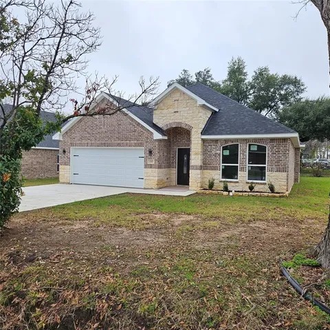 a front view of a house with a garden