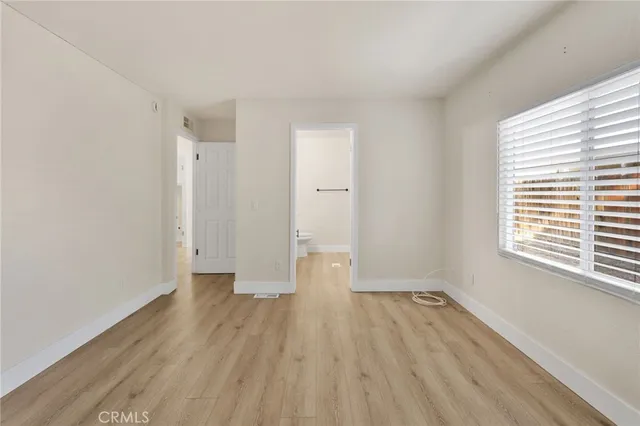 a view of a room with wooden floor and window