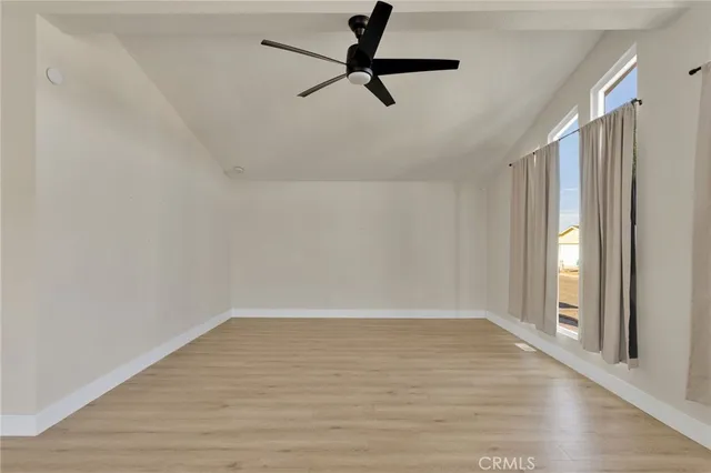 a view of a room with wooden floor and window