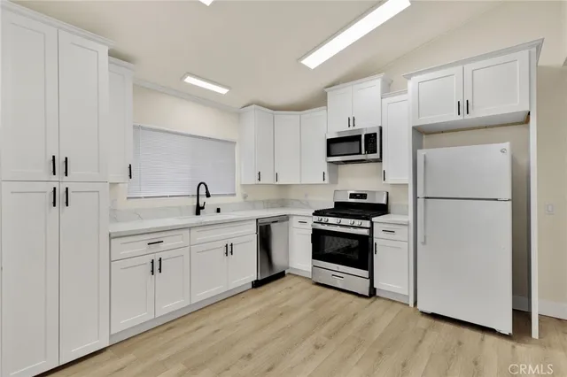 a kitchen with a refrigerator stove and sink