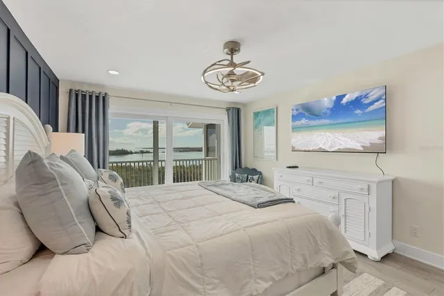 a bedroom with a large bed and a window