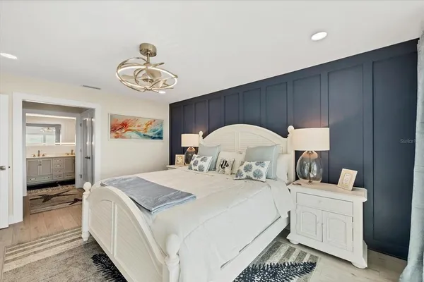 a bedroom with a bed and a chandelier
