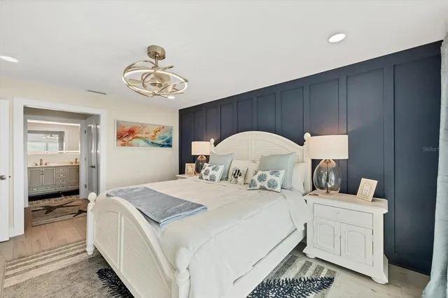 a bedroom with a bed and a chandelier