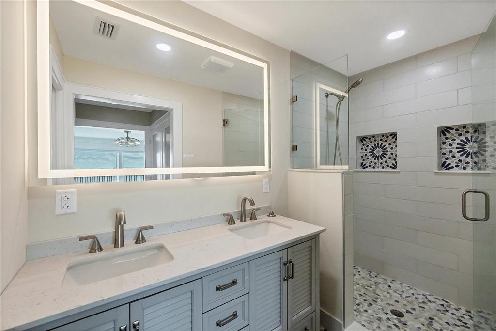 6000 Boca Grande Causeway, Unit D47 Boca Grande, FL 33921 - Photo 15 of 22 a bathroom with a double vanity sink a toilet and a mirror