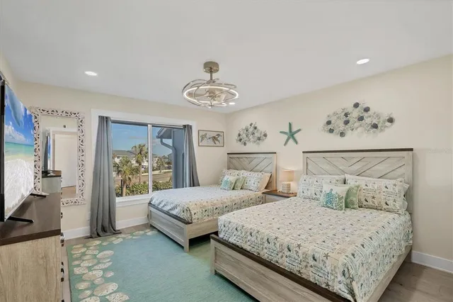 a bedroom with a large bed and a chandelier