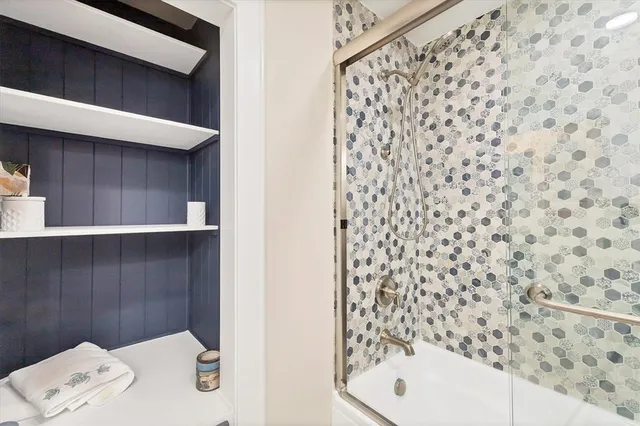 a bathroom with a bathtub and shower