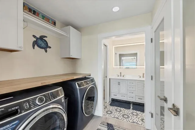 a view of bathroom with washing machine and mirror