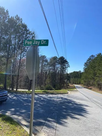 a sign board with water fountain in the background