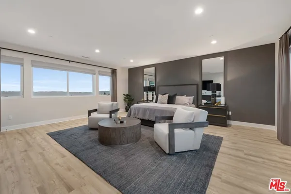 a bedroom with bed and wooden floor