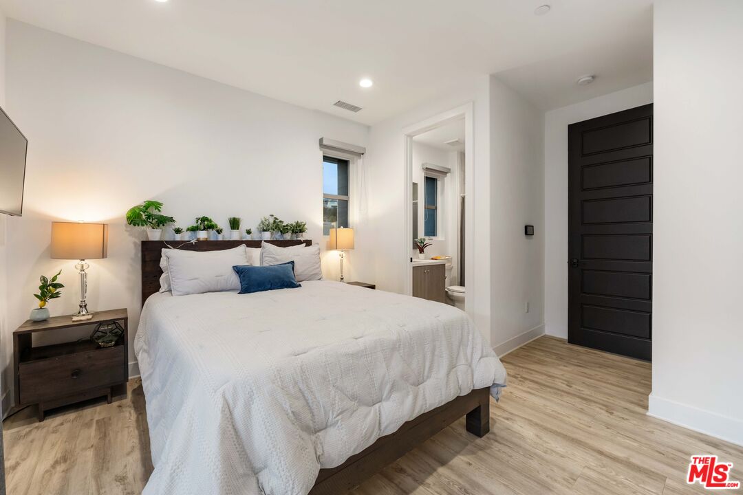 20524 Shelley Lane Porter Ranch, CA 91326 - Photo 55 of 73 a bedroom with bed and wooden floor