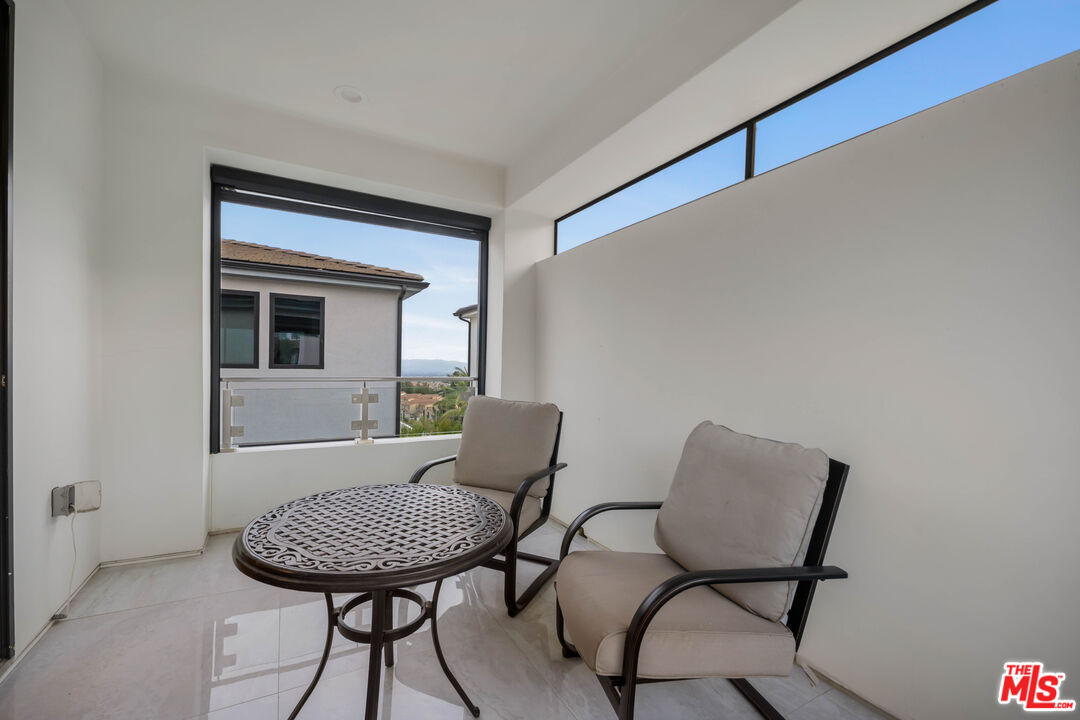 20524 Shelley Lane Porter Ranch, CA 91326 - Photo 57 of 73 a view of a hallway with furniture and wooden floor