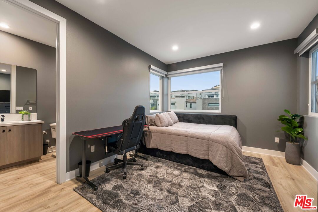 20524 Shelley Lane Porter Ranch, CA 91326 - Photo 59 of 73 a bedroom with a bed table chair and a window