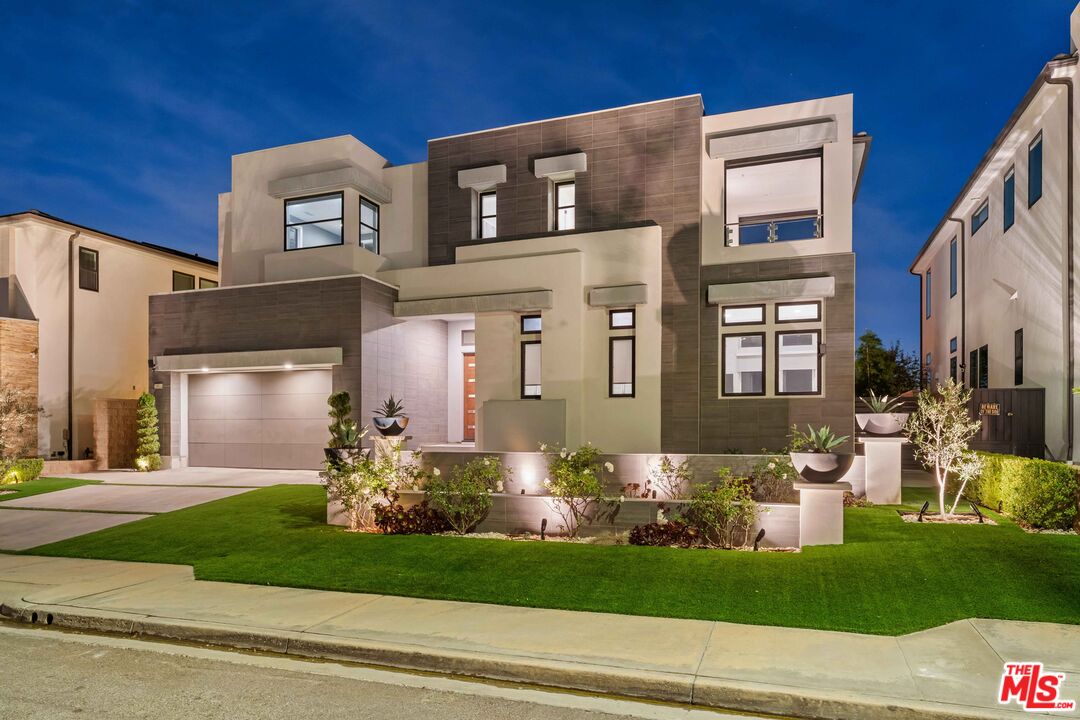 20524 Shelley Lane Porter Ranch, CA 91326 - Photo 62 of 73 a front view of a house with a garden and plants