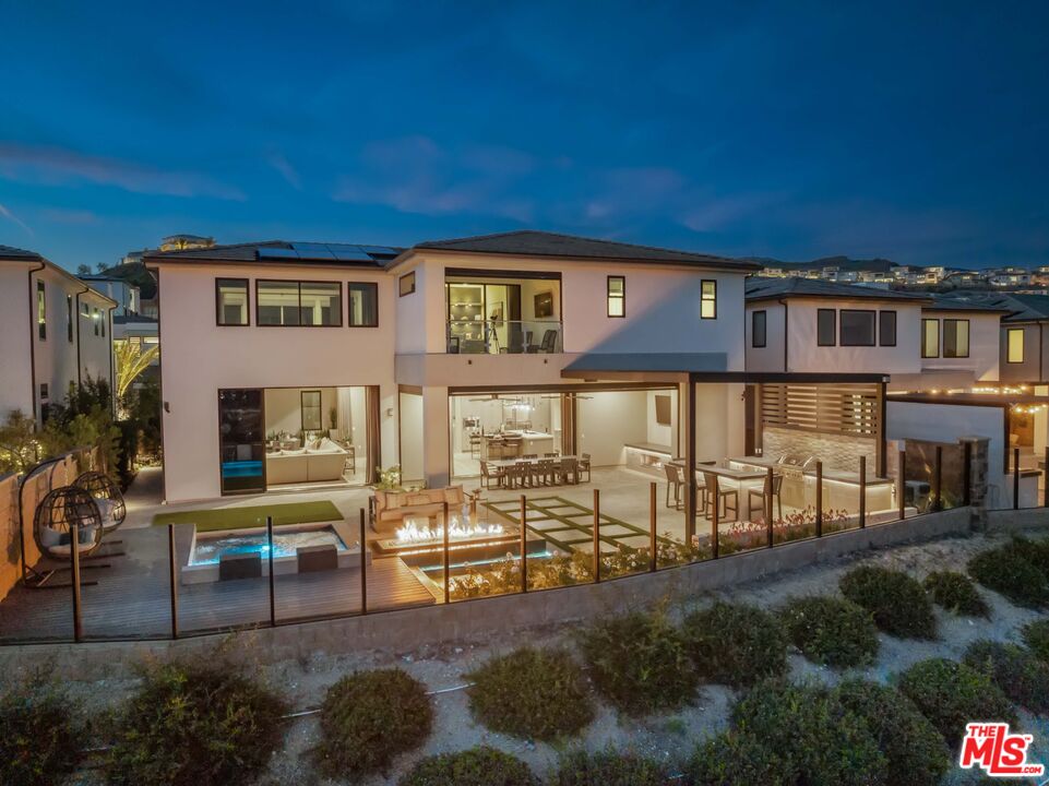 20524 Shelley Lane Porter Ranch, CA 91326 - Photo 68 of 73 a view of a house with backyard porch and sitting area