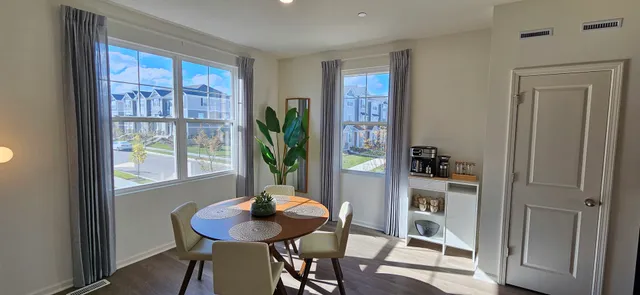 a view of a dining room with furniture and a window