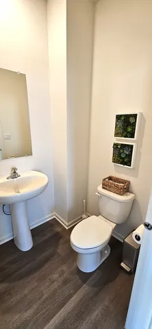 a white toilet sitting next to a bathroom sink