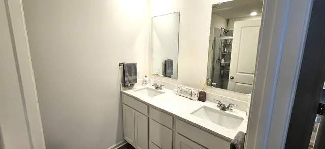 a bathroom with a double vanity sink and a mirror