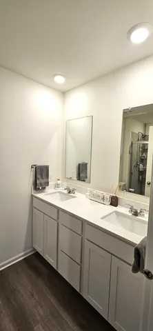 a bathroom with a double vanity sink and mirror