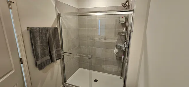 a bathroom with a shower and a sink