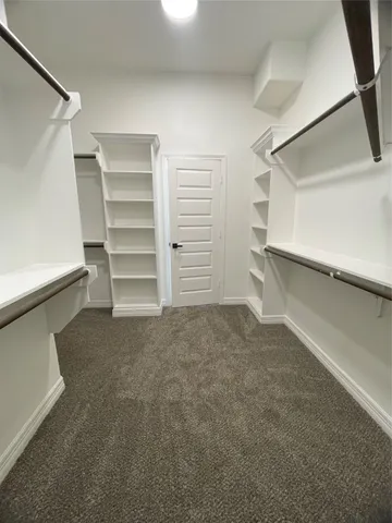 a bathroom with a double vanity sink a mirror and a bathtub