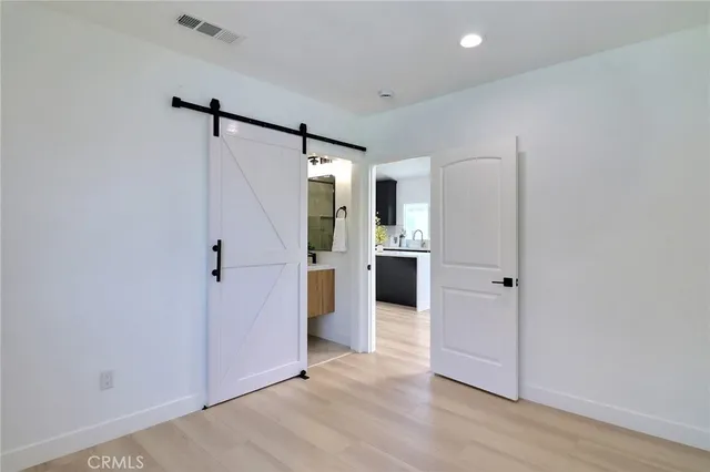 a view of a kitchen with a sink and a refrigerator