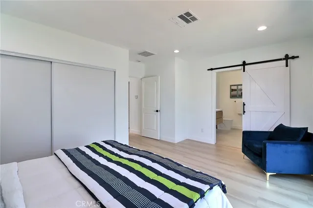 a bedroom with a bed and a dresser