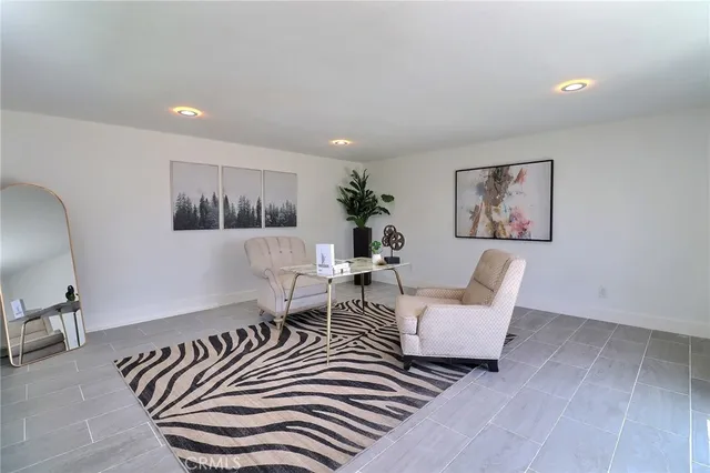 a living room with couches and painting on the wall