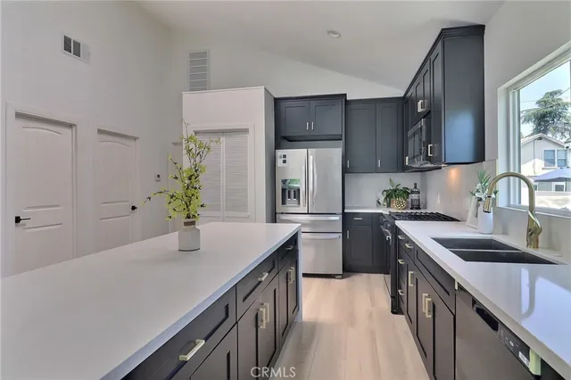 a kitchen with a sink stove and refrigerator