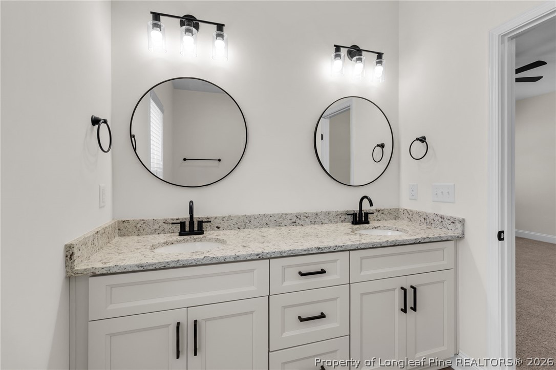 131 Merle Road Pinebluff, NC 28373 - Photo 19 of 33 a bathroom with double vanity sinks and a mirror