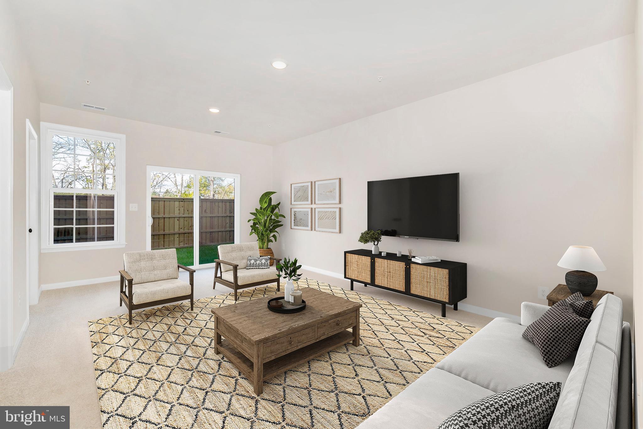 107 Spring Bank Way Frederick, MD 21701 - Photo 2 of 13 a living room with furniture and a flat screen tv